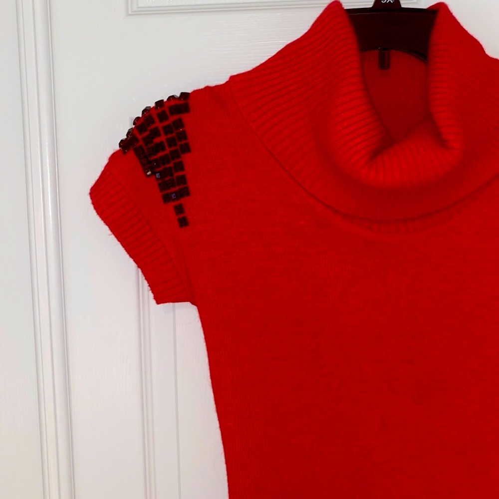 Cowlneck ribbed, red sweater dress with rhinestone embellishment on shoulders.